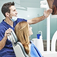 Dentist and patient looking at virtual smile design