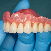 Dentist holding dentures