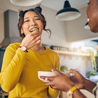 Group of friends smiling while enjoying meal together