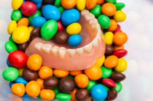 A denture piled underneath hard candy